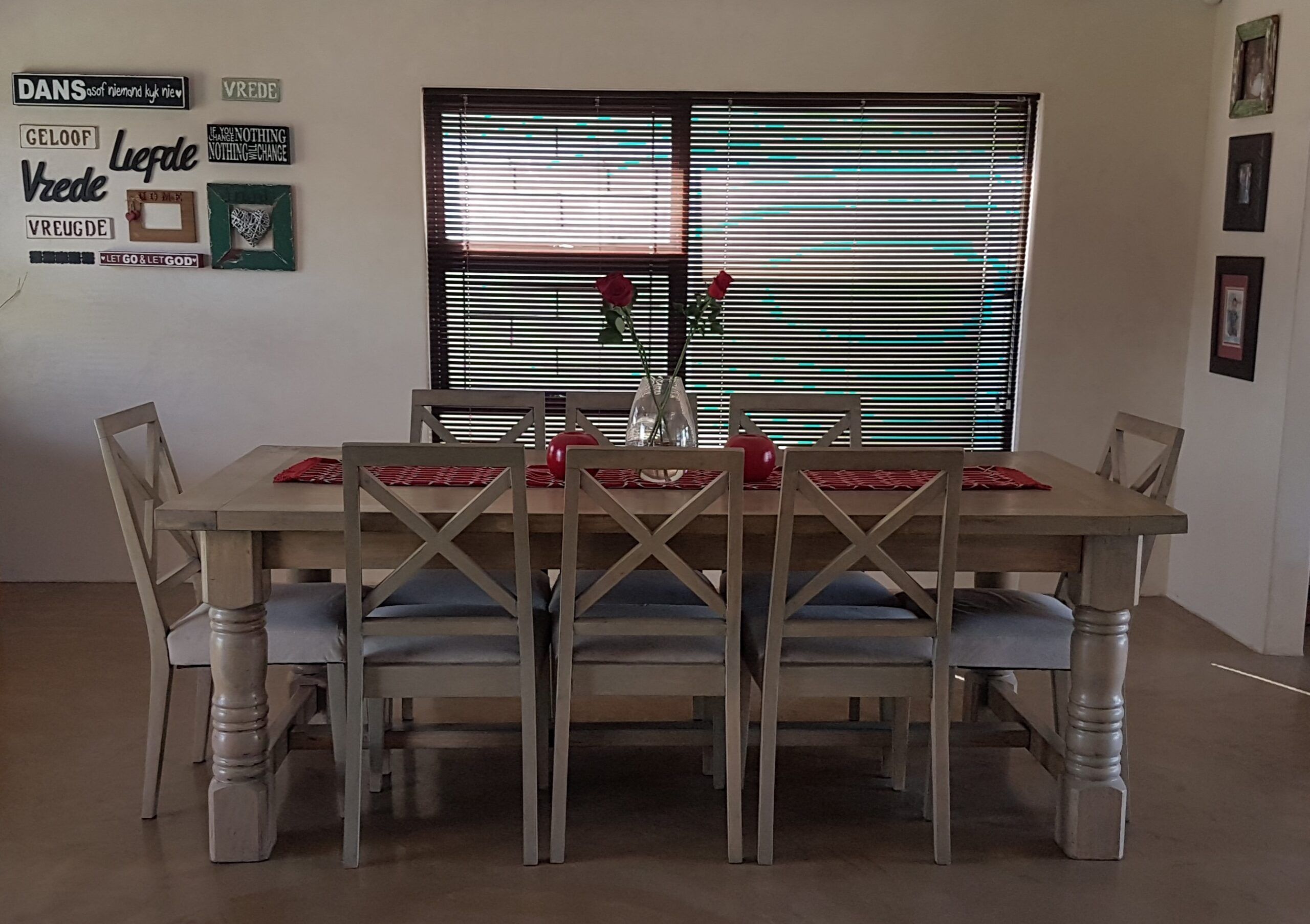 Smooth grey-brown cement screed floor in a dining room with farmhouse table and chairs
